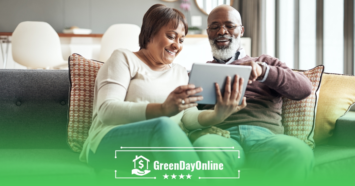 A man and woman sitting on a couch looking at a tablet searching for credit options from lenders